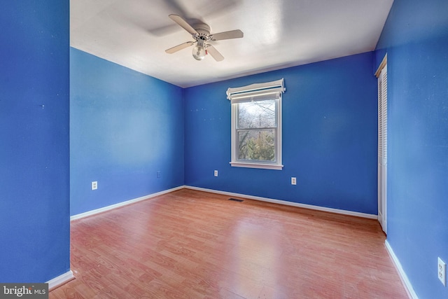 spare room featuring ceiling fan and hardwood / wood-style floors