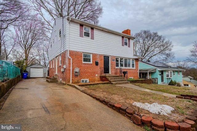 view of front of property featuring a garage and an outbuilding