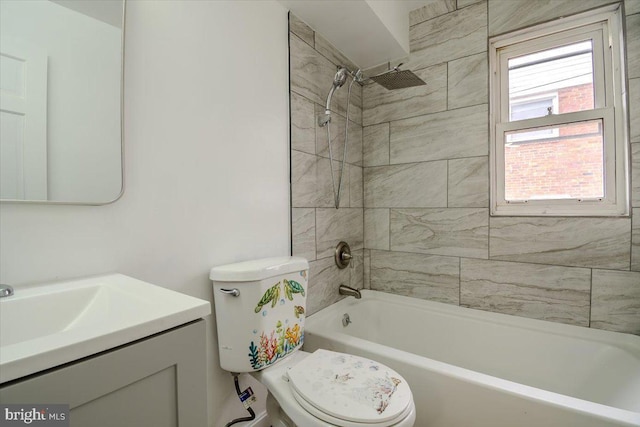 full bathroom with tiled shower / bath combo, vanity, and toilet