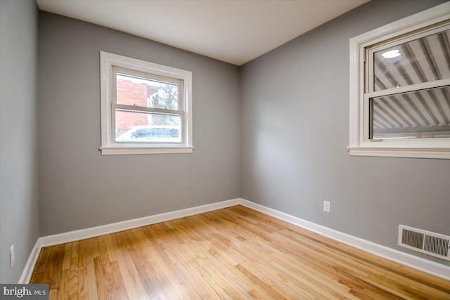 empty room with light hardwood / wood-style floors