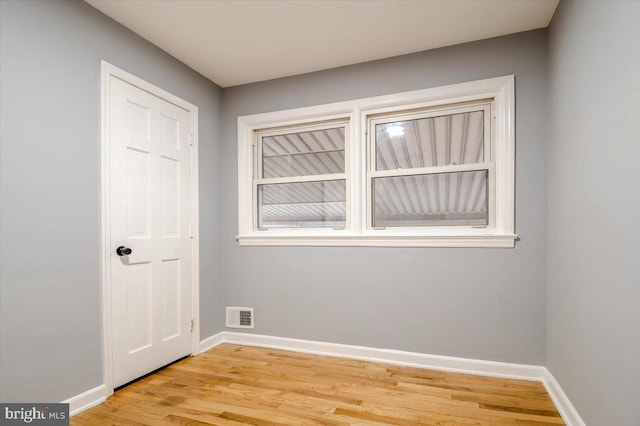 empty room with hardwood / wood-style flooring