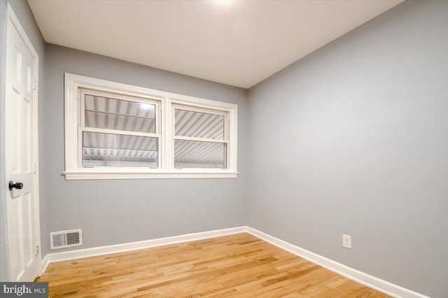 spare room featuring hardwood / wood-style flooring