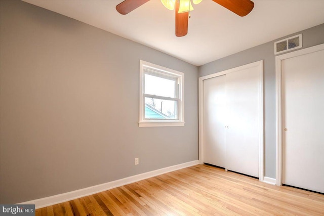 unfurnished bedroom featuring light wood-type flooring and ceiling fan