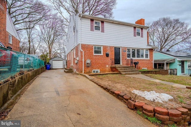 view of front of property with a garage and an outbuilding