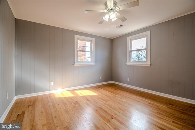 empty room with light hardwood / wood-style floors and ceiling fan