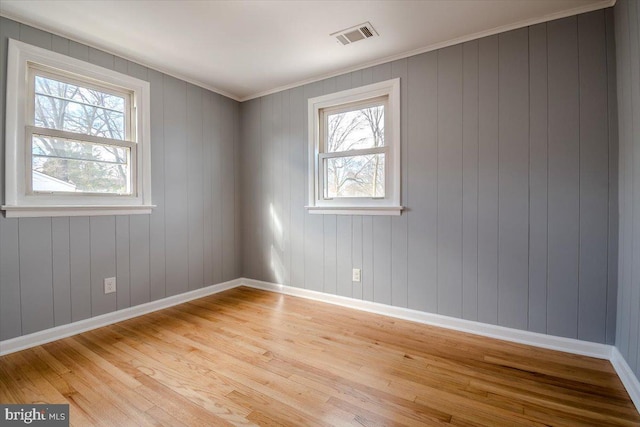 unfurnished room featuring light hardwood / wood-style flooring and a wealth of natural light