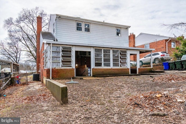 back of house with central AC