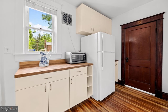2902 Shirey Ave, Baltimore, MD 21214 - kitchen featuring wooden counters, freestanding refrigerator, dark wood-type flooring, and white cabinets