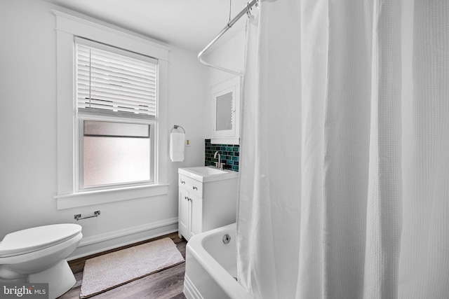 2902 Shirey Ave, Baltimore, MD 21214 - full bath with wood finished floors, toilet, vanity, baseboards, and curtained shower