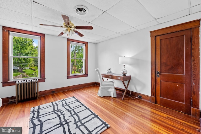 2902 Shirey Ave, Baltimore, MD 21214 - office with radiator, light wood-style flooring, baseboards, a paneled ceiling, and ceiling fan