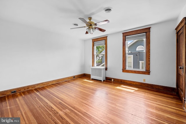 2902 Shirey Ave, Baltimore, MD 21214 - unfurnished room with baseboards, a ceiling fan, light wood-type flooring, and radiator
