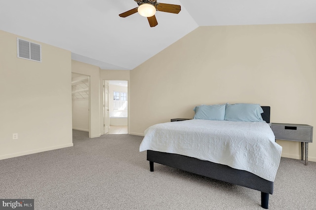 carpeted bedroom featuring baseboards, visible vents, a ceiling fan, lofted ceiling, and a spacious closet