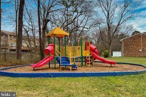 community jungle gym with a yard