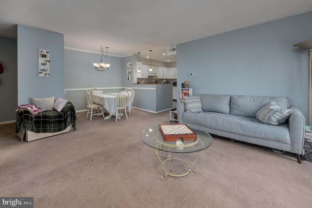 living area with baseboards, ornamental molding, a notable chandelier, and light colored carpet