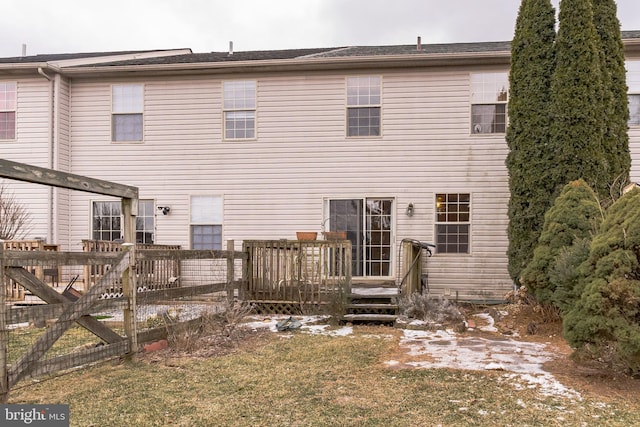 rear view of house with a deck and a lawn