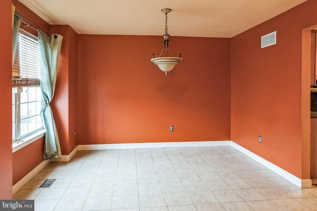 unfurnished dining area with visible vents, baseboards, and light tile patterned floors