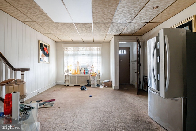 interior space with carpet and a paneled ceiling