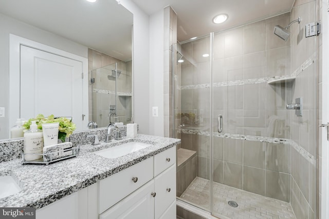 full bath featuring a stall shower and vanity