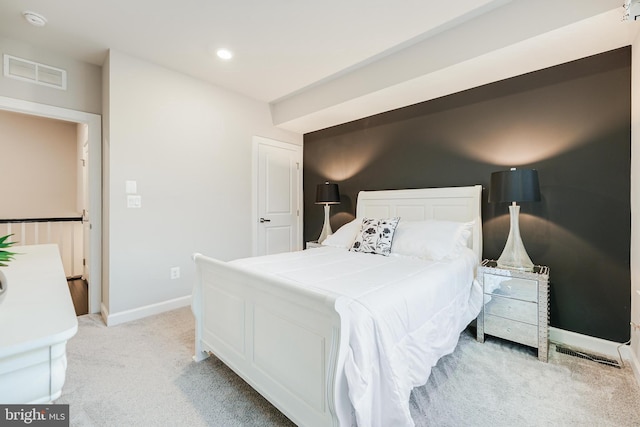 bedroom with recessed lighting, visible vents, light carpet, and baseboards