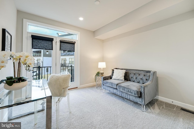 living room with recessed lighting, visible vents, baseboards, and light colored carpet