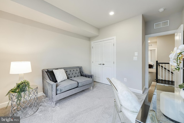 living room with baseboards, recessed lighting, visible vents, and light colored carpet