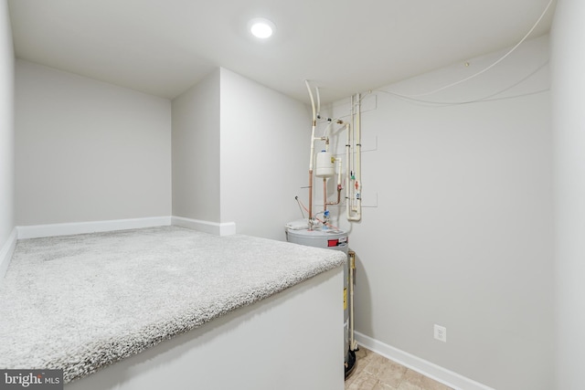 interior space with electric water heater and baseboards