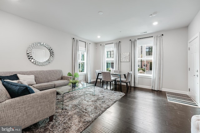 living room with recessed lighting, dark wood finished floors, visible vents, and baseboards