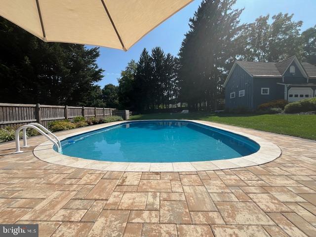 view of swimming pool with a fenced in pool, a patio area, and fence