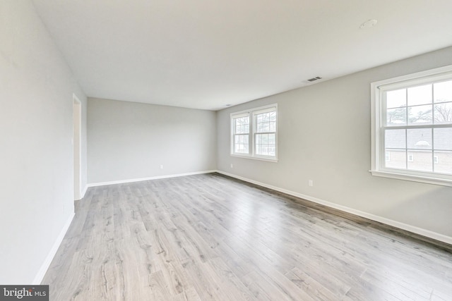 unfurnished room with light hardwood / wood-style flooring