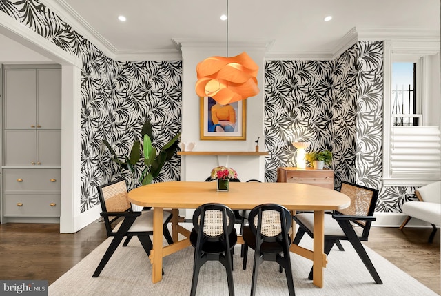 dining area with ornamental molding, dark wood-style flooring, recessed lighting, and wallpapered walls