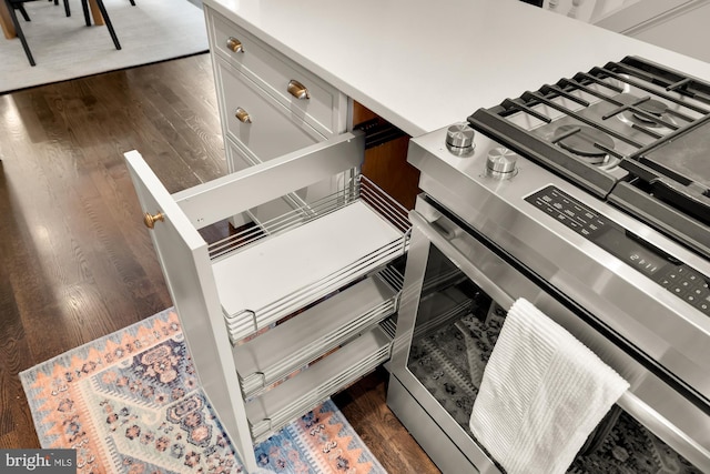 kitchen with dark wood-style flooring and stainless steel range with gas stovetop