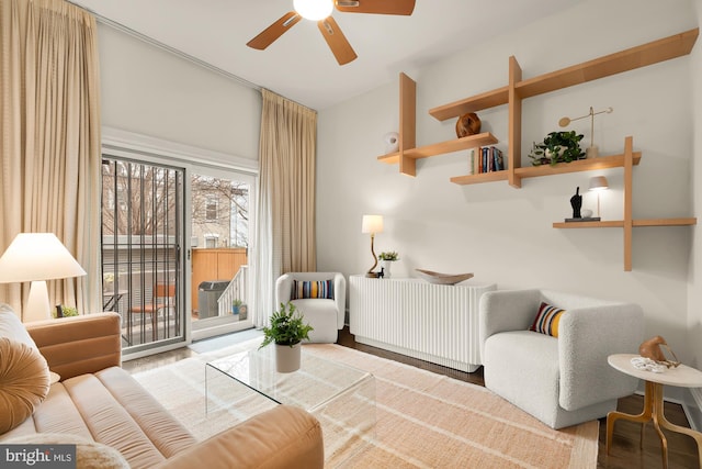 living room featuring a ceiling fan and wood finished floors