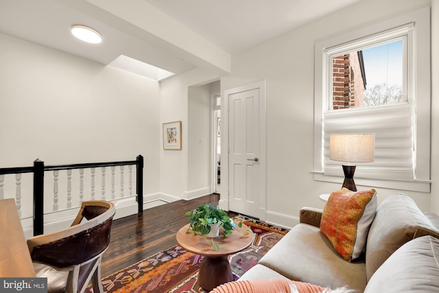 living area with dark wood finished floors and baseboards