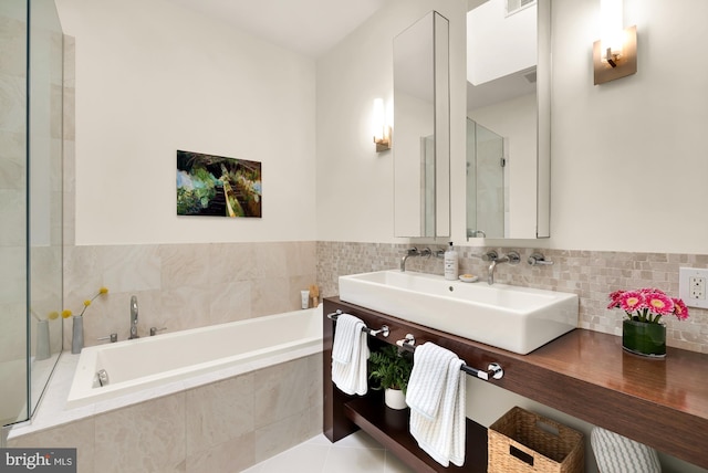 full bathroom with double vanity, a sink, tile patterned flooring, an enclosed shower, and a bath