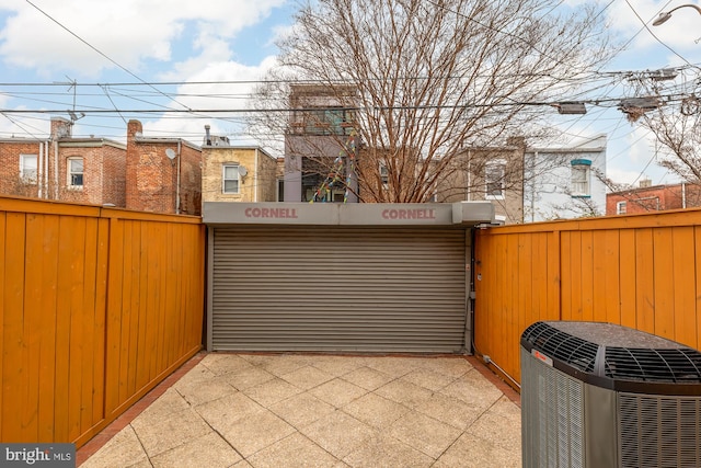 exterior space with central air condition unit and fence