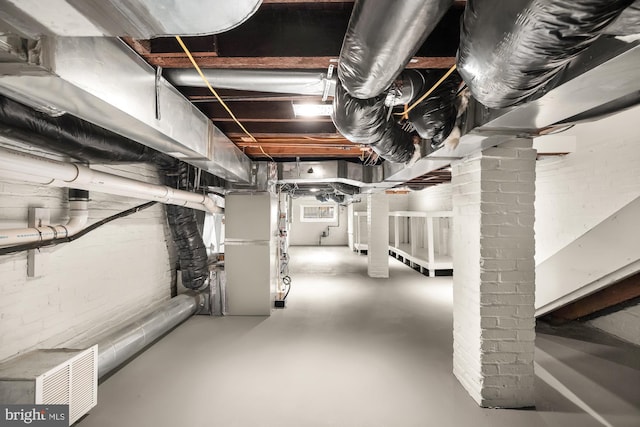 unfinished basement featuring heating unit