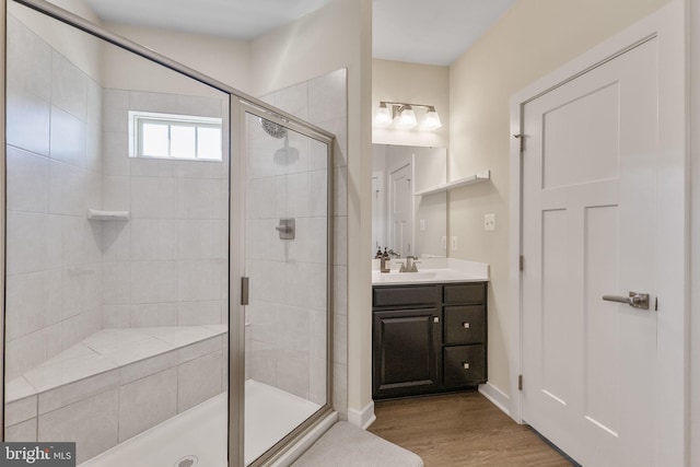 full bath with wood finished floors, a shower stall, and vanity