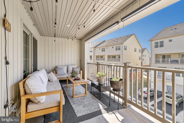 balcony with a residential view and an outdoor hangout area