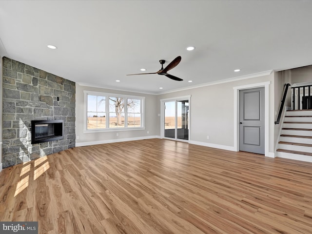 unfurnished living room with a fireplace, crown molding, and a healthy amount of sunlight