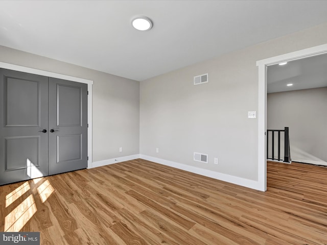 unfurnished bedroom featuring a closet and light hardwood / wood-style floors