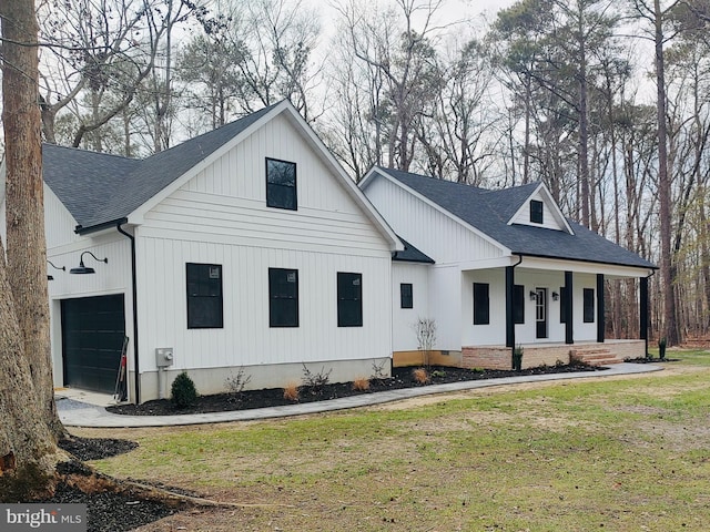 view of front facade featuring a porch, roof with shingles, an attached garage, and a front lawn