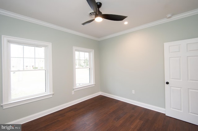 spare room with ornamental molding, dark wood finished floors, and baseboards