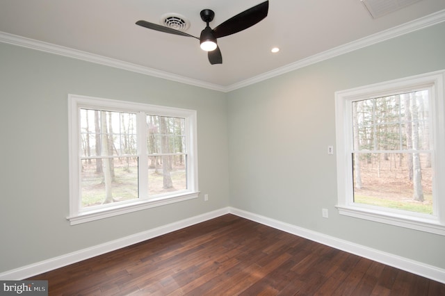 spare room featuring ornamental molding, dark wood finished floors, and baseboards