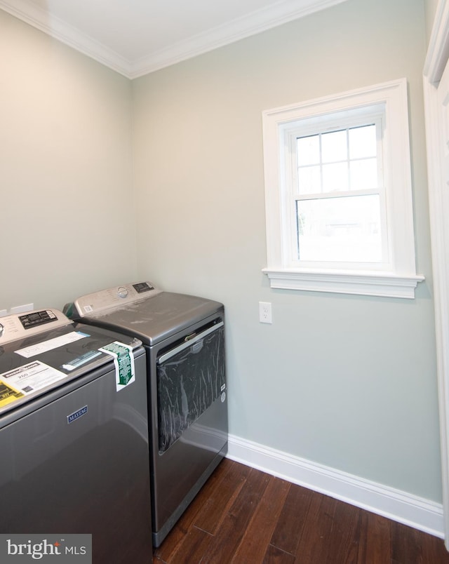 laundry area with laundry area, baseboards, washer and clothes dryer, dark wood-style flooring, and crown molding