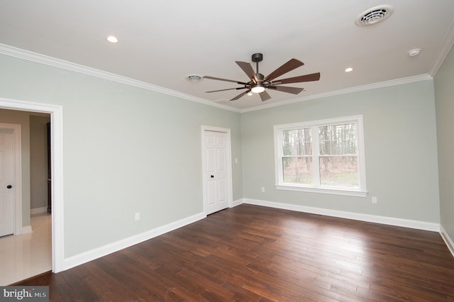 unfurnished room featuring ornamental molding, dark wood-style flooring, visible vents, and baseboards