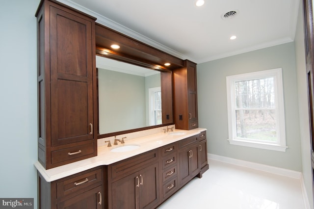 bathroom with double vanity, ornamental molding, a sink, and visible vents