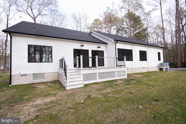 view of front of home with roof with shingles, a front lawn, crawl space, and a wooden deck