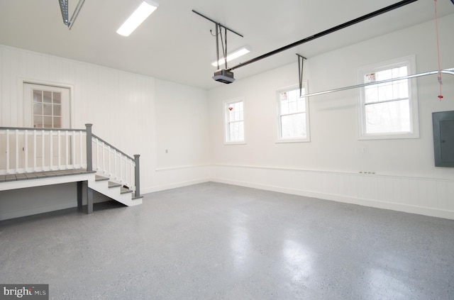 garage with electric panel and a garage door opener