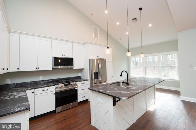 kitchen featuring visible vents, an island with sink, stainless steel appliances, pendant lighting, and a sink