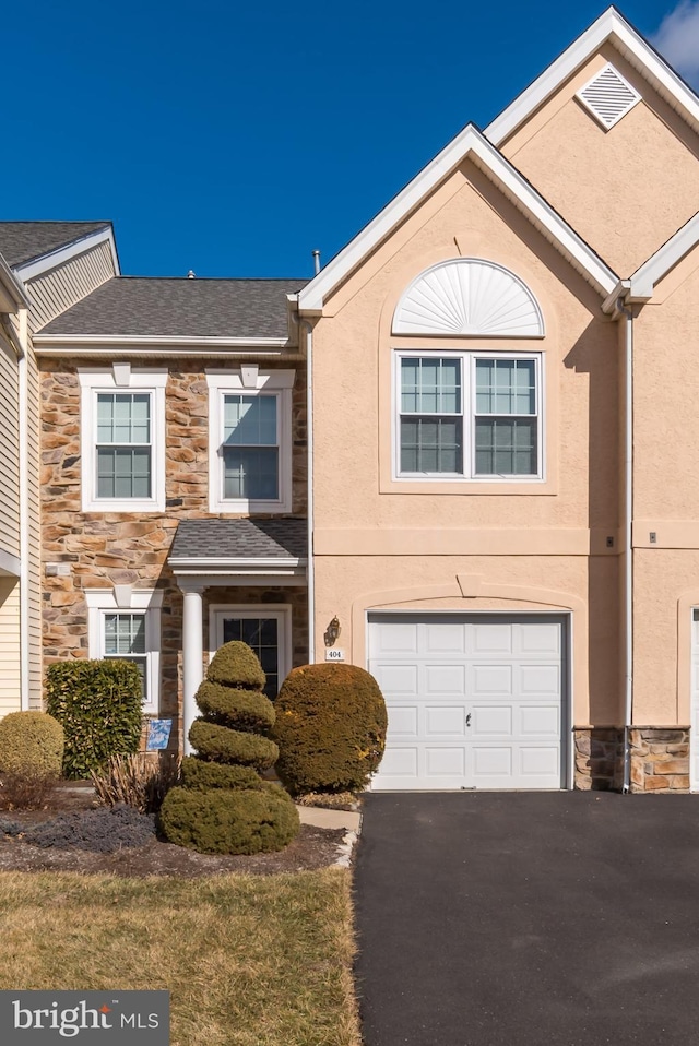 townhome / multi-family property featuring a garage